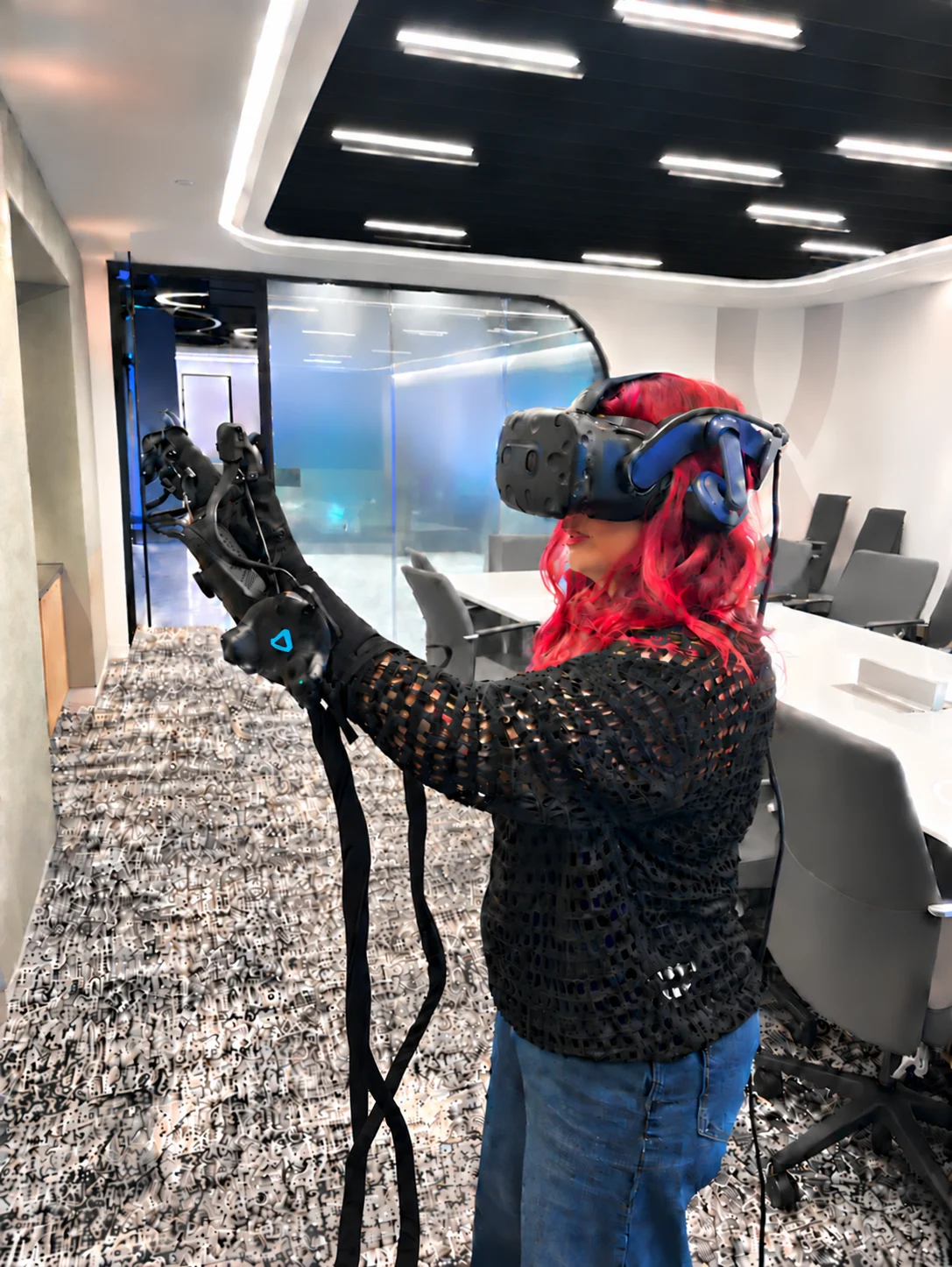 Layla exploring virtual reality with a headset and haptic gloves
